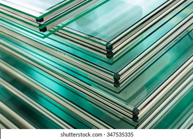 Sheets of Factory manufacturing tempered clear float glass panels cut to size - Shutterstock ID 347535335