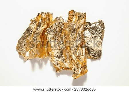 Sheets of gold foil, flat lay. Thin golden foil pieces for art decor, potal