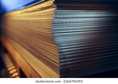 Sheets of metal in a stack in a warehouse