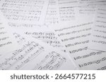 Sheets with musical notes as background, closeup