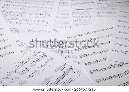 Sheets with musical notes as background, closeup