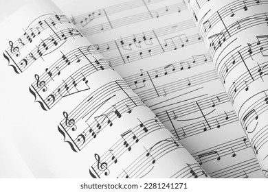 Sheets of paper with music notes as background, closeup view