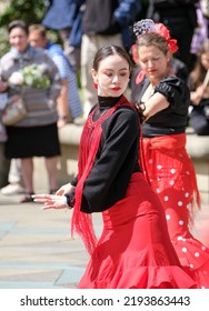 Sheffield, South Yorkshire, UK
July 2  2022
Flamenco Dancers In Sheffield Display Their Skills In This Annual Street Festival Of Dance. A Young Chinese Woman Is In The Foreground.