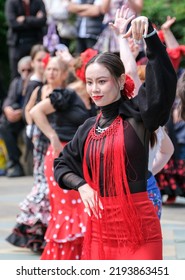 Sheffield, South Yorkshire, UK
July 2  2022
Flamenco Dancers In Sheffield Display Their Skills In This Annual Street Festival Of Dance. A Young Chinese Woman Is In The Foreground.