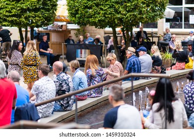 SHEFFIELD, UK - 20TH JULY 2019: Crowds Of People Sit In A Square In Sheffield City Centre For Tramlines Watching A Band Play