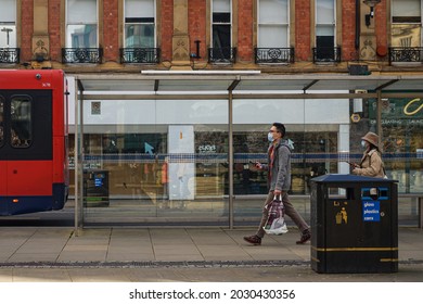 Sheffield, UK - March 20, 2020: People Were Wearing Face Masks While Walking Past A Bus Stop In Central Sheffield Near Peace Garden Before The First Lockdown In The UK. 