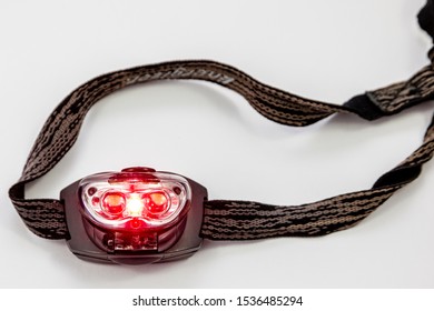 SHEFFIELD, UK – OCTOBER 12, 2019: A Red Light LED Head Torch For Night Reading, To Limit Blue Light, To Help Night Vision In Camping, Astronomy