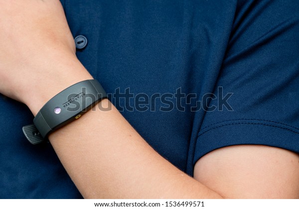 SHEFFIELD, UK – OCTOBER 12, 2019: A young\
sports person wearing a Philips Respironics Actiwatch, a clinical\
research-grade tracker watch for insomnia, sleep studies and\
activity monitoring