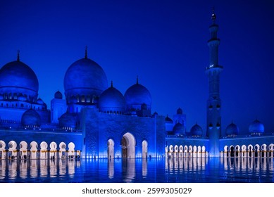 Gran mezquita Sheikh Zayed en Abu Dhabi iluminada de azul por la noche, Emiratos Árabes Unidos