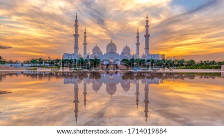 Sheikh Zayed Grand Mosque and Reflection in Fountain at Sunset with clouds - Abu Dhabi, United Arab Emirates (UAE)
