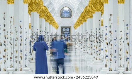Sheikh Zayed Grand Mosque timelapse in Abu Dhabi, the capital city of United Arab Emirates. People walking between columns.