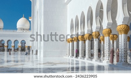 Sheikh Zayed Grand Mosque timelapse in Abu Dhabi, the capital city of United Arab Emirates. Inner court yard. Blue sky at sunny day