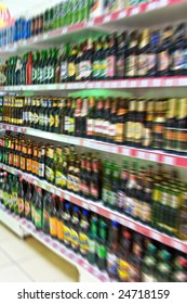 Shelf With Beer Bottles In A Supermarket, Blur