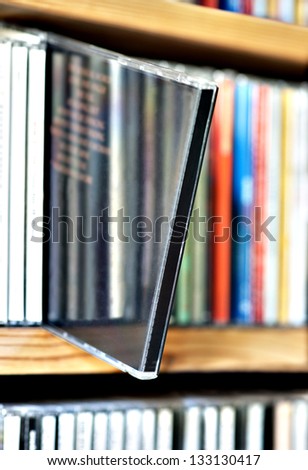 Shelf with CDs with one sticking out