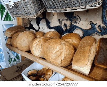 A shelf filled with lots of different types of bread.