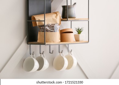 Shelf with kitchenware on light wall - Powered by Shutterstock