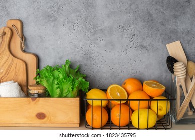 Shelf In A White Kitchen With Fresh Fruits, Herbs, Cutlery, Kitchen Utensils, Tools, Textiles, Fresh Water In A Decanter. Home, Family, Simplicity