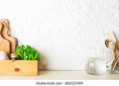 Shelf In A White Kitchen With Fresh Fruits, Herbs, Cutlery, Kitchen Utensils, Tools, Textiles, Fresh Water In A Decanter. Home, Family, Simplicity