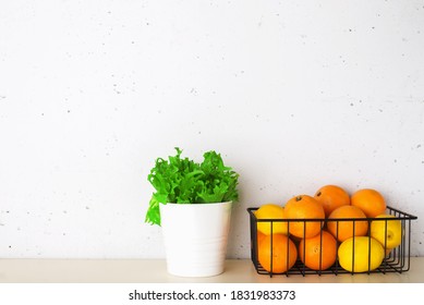 Shelf In A White Kitchen With Fresh Fruits, Herbs, Cutlery, Kitchen Utensils, Tools, Textiles, Fresh Water In A Decanter. Home, Family, Simplicity