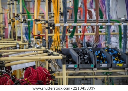 shelf with wires and connectors in a wire harness factory