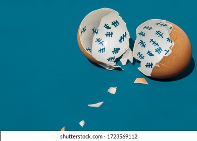The shell of a broken egg lies on a blue table. Inside the shell, the days of release from captivity were counted. Tally chart. - Shutterstock ID 1723569112