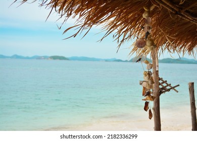 shell necklace on a thatched bamboo hut on the beach of a tropical island, beautiful view of the beach. copy space