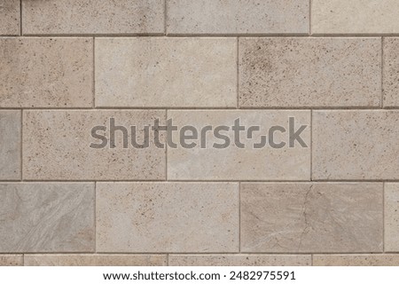 Shell stone tile wall as background.Old natural block wall with rough surface