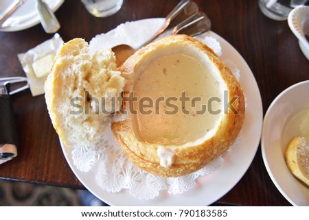 Shellfish Soup is in the bread on the white plate.