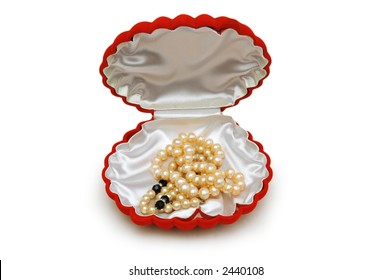 Shell-shaped red box and pearls isolated on white
