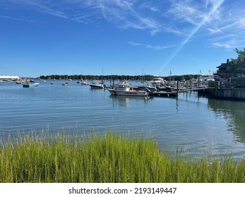 Shelter Island, NY, USA, 8.14.22 - Looking Across The Bay At The Docked Boats On Shelter Island. In Front Is The Fire Rescue Speed Boat That Is Tied Up Onto The Pier.