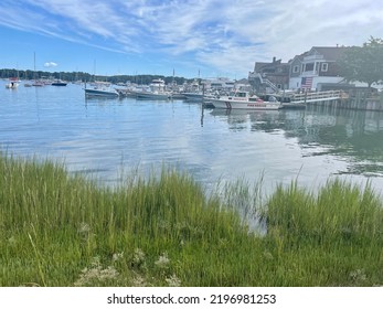 Shelter Island, NY, USA, 8.14.22 - Looking Across The Bay At The Docked Boats On Shelter Island. In Front Is The Fire Rescue Speed Boat That Is Tied Up Onto The Pier.