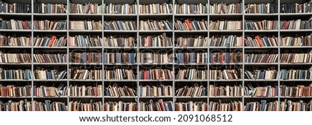 shelves with books in library background