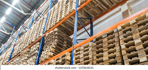 Shelves In Distribution Warehouse And Wooden Pallets