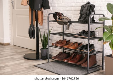 Shelving rack with stylish shoes and accessories near white brick wall indoors - Shutterstock ID 1646761936