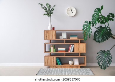 Shelving unit with books and decor in interior of room - Shutterstock ID 2059537070