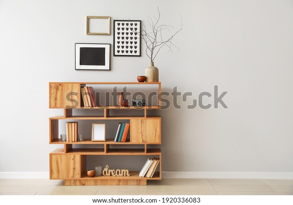 Shelving\
unit with books and decor in interior of\
room