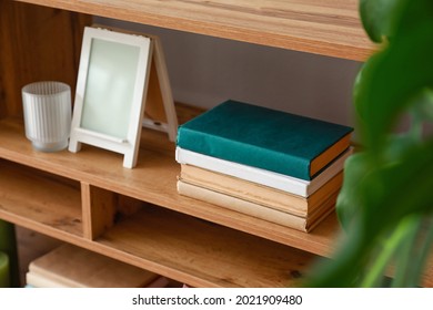 Shelving unit with books in interior of room
