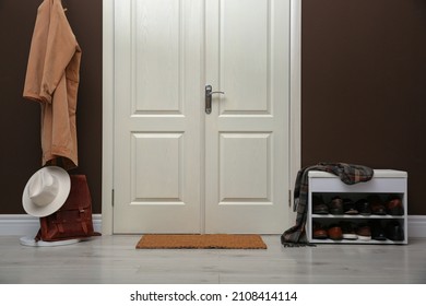 Shelving Unit With Shoes, Coat Rack And Door Mat In Hall