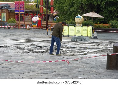 Shenzhen, China - 14 January, 2016 - Shenzhen Splendid China Folk Village Theme Park. Worker Using Jackhammer To Remove Tiles