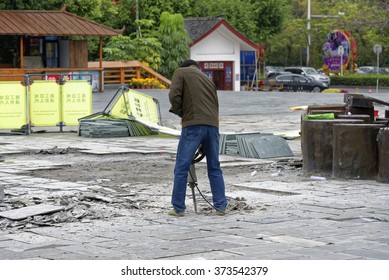 Shenzhen, China - 14 January, 2016 - Shenzhen Splendid China Folk Village Theme Park. Worker Using Jackhammer To Remove Tiles