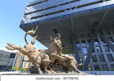 Shenzhen, China - August 19,2015: Stock market building in Shenzhen, one of the three stock markets in China, with the copper bull statue on foreground. 