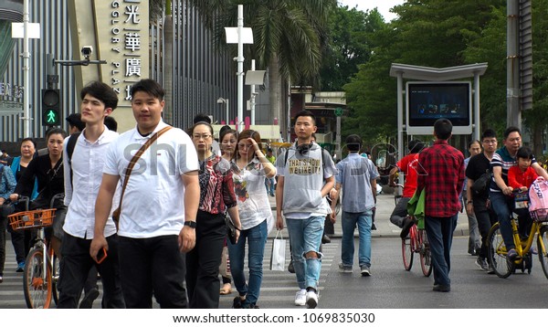 SHENZHEN, CHINA - CIRCA APRIL 2018 : FACIAL\
RECOGNITION TECHNOLOGY at street to identify jaywalkers and\
automatically issue them fines by text.  Offenders faces are\
displayed on screens at\
crossings.