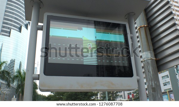 SHENZHEN, CHINA - CIRCA NOVEMBER 2018 : FACIAL\
RECOGNITION TECHNOLOGY to identify jaywalkers and automatically\
issue them fines by text.  Offenders faces are displayed on screens\
at crossings.