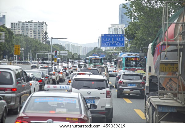 Shenzhen, China - Jun 13, 2016: Traffic jam at\
rush hour on a busy street of Shenzhen after work. Shenzhen\
together with Shanghai and Tianjin are cities that car ownership\
exceeds 2 millions.