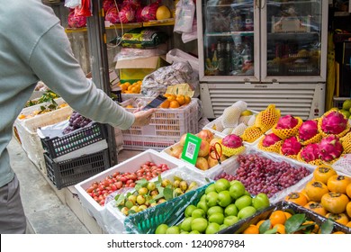 Shenzhen, China - November 14 2018: A customer pays his purchase with Qr code at a fruit market stand. Digitalization, such as cashless payment, in daily life is being widely accepted in China