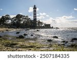 Shepelevsky lighthouse on the shore of the Gulf of Finland on a sunny summer day. Leningrad region, Russia