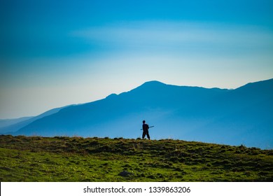 Shepherd Walking Holding A Rod In His Hands, Mountain Landscape