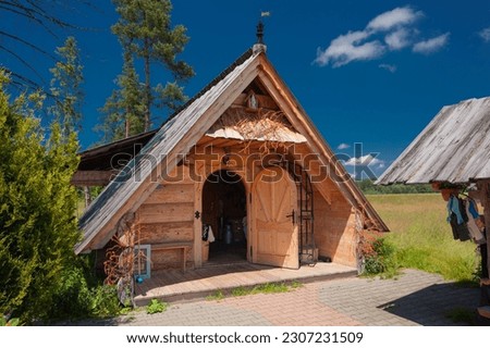 Shepherd's hut on Baligowka in Czarny Dunajec. and surroundings. Wooden mountain hut in the green field. 