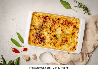 Shepherd's Pie with ground beef, potato and cheese on white background, top view, copy space. Traditional homemade potato casserole with herbs - Powered by Shutterstock