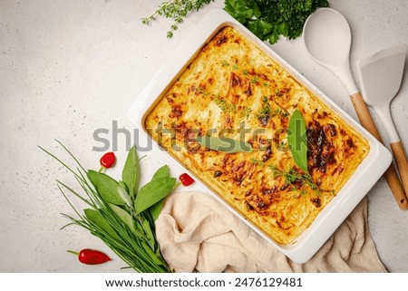 Shepherd's Pie with ground beef, potato and cheese on white background, top view, copy space. Traditional homemade potato casserole with herbs